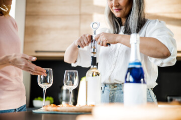 Happy pretty ladies going to drink wine