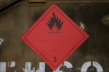 An LPG tank secured with a strong chain and showing a Flammable Gas