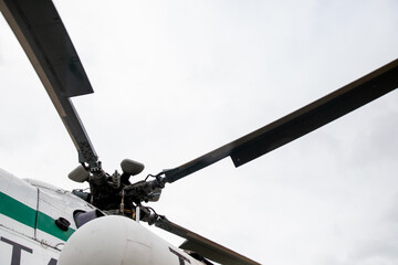 Helicopter blades against the sky with clouds