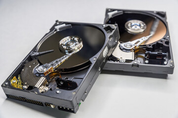 Old fashioned, open, mechanical harddisc drives, isolated on a white background