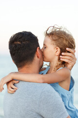 Dad with daughter by the sea.