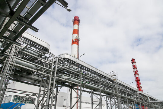 Territory of thermal power plant, red pipes, industrial buildings