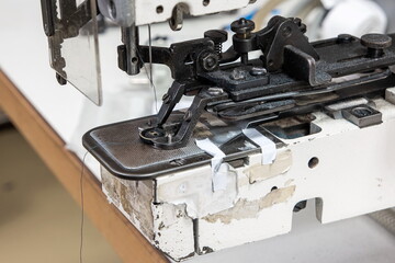 Fototapeta na wymiar Generic old semi-professional sewing machine close up shot on the test bench