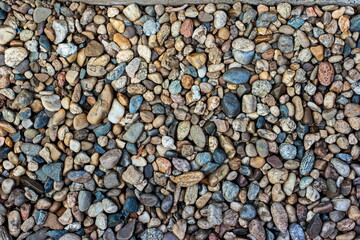 Pile of flat small colored mosaic of pebbles top view