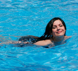 young woman smiling in a swimming pool