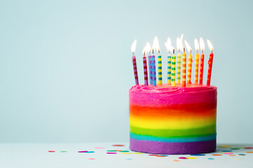Rainbow birthday cake with colorful candles