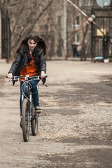 Teen girl rides down the street on a sports bike