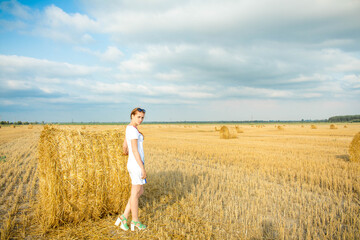 girl in a white dress in a wheat field