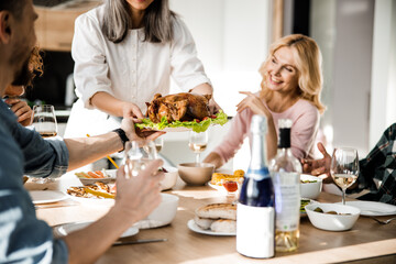 Lady putting food on the festive table for her guests