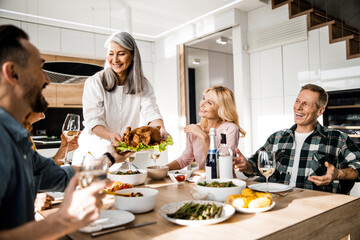 Happy man is helping his female friend to set the table