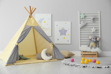 Stylish child's room interior with adorable paintings and play tent © New Africa