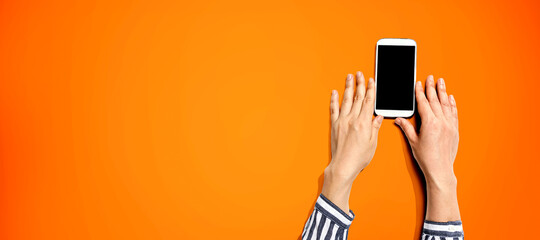 Person using a white smartphone from above