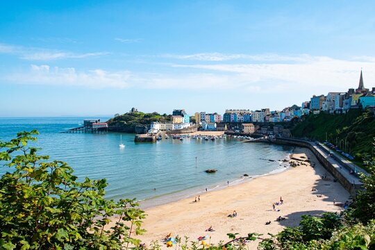Tenby North beach sandy beach with the pinnacle of Goskar rock sticking out of the sand in the middle. 
