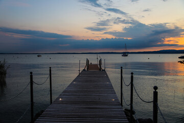 Fototapeta premium Sunset with landing stage in Bardolino, Italy