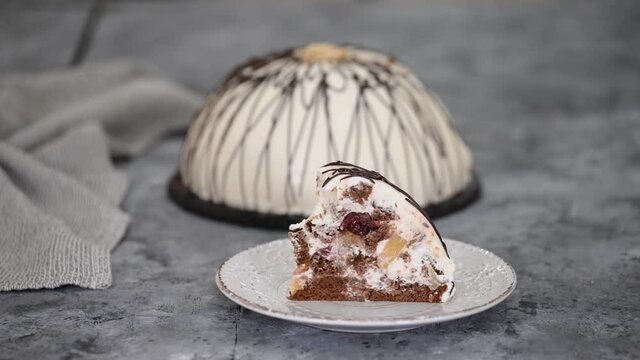 Piece of Pancho cake with pineapple and sour cream topped with chocolate and nuts.