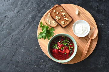 Traditional Ukrainian Russian vegetable soup, borsch with garlic donuts and bread
