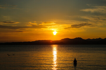 Sunset in Bardolino on Lake Garda with mountains in the background