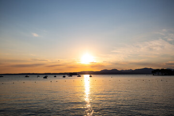 Sunset in Bardolino on Lake Garda with mountains in the background