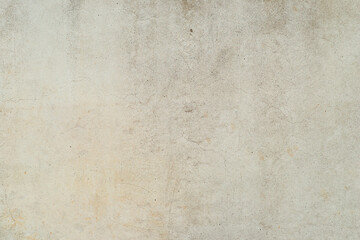 A seamless detailed background made of a gray concrete wall with natural lighting.