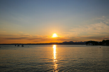 Sunset in Bardolino on Lake Garda with mountains in the background