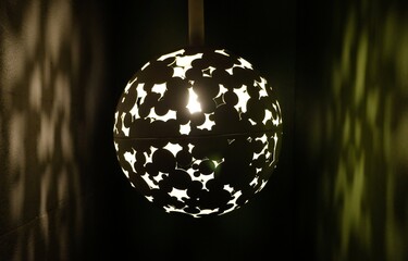 low lit decorative lamp in a hall with a green wall