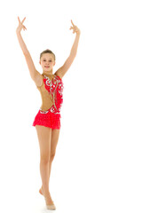 Fototapeta premium A little girl does gymnastic exercises.