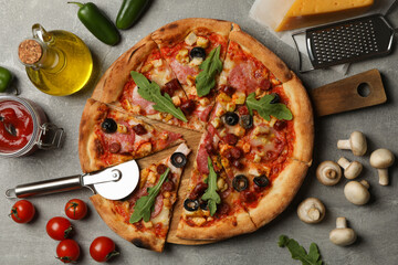 Tasty pizza and ingredients on gray background