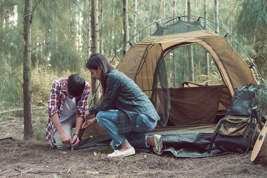 A couple trying to pitch a tent