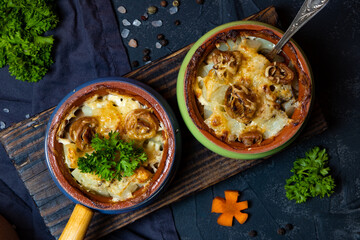  Julienne in portioned pots on a black background, top view, close-up