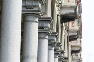 Palace architecture with colonnade and eclectic capitals from the early 1900s, with a square linear...