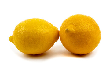 two whole yellow sour lemons isolated on white
