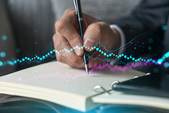 Businessman in suit taking notes. Multiexposure with forex graph hologram. Man writing down important information in his business diary. Financial trading concept. - Powered by Adobe