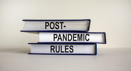 Books with text 'post-pandemic rules' on beautiful white background. Business and post-pandemic concept. Copy space.