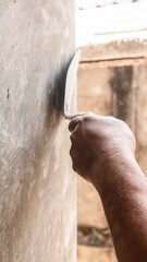 Tiler's hand.bricklayer plaster a wall inside a building