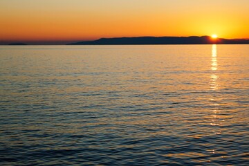Fishing boat at sunset around the bay of Kardamyli village in Messiniaki Mani region of south Peloponnese in Greece.