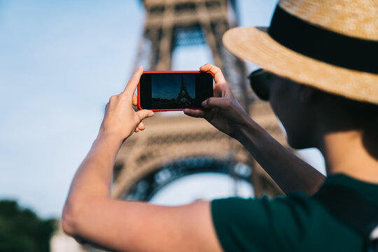 Female tourist shooting Eiffel Tower