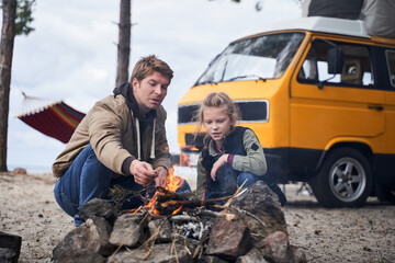Daughter communicates with dad near the fire