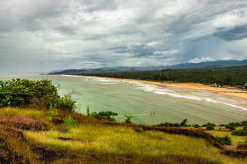 mountain top view of sea shore with clouded sky
