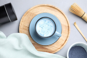 Flat lay composition with blue matcha latte on grey table