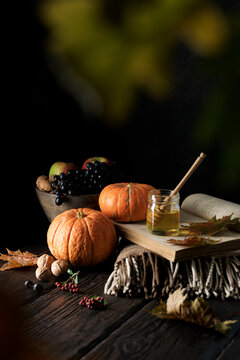 Dark Mood Still Life Autumn Composition. Autumn Harvest Of Vegetables, Fruits And Honey On A Wooden Table. Traditional Seasonal Food