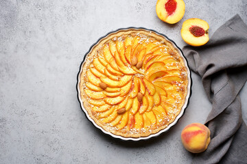 Peach tart with almonds. Homemade dessert. Top view, food concrete background
