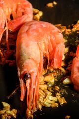 Shrimp with garlic roast in a pan. Close up.