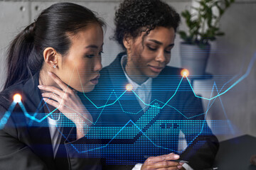Two businesswomen work together in modern office on new project. Double exposure. Concept of success. Financial graph.
