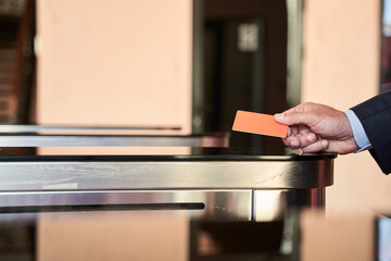 Man entering office via turnstile