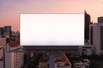 Obraz premium Blank white road billboard with Bangkok cityscape background at night time. Street advertising poster, mock up, 3D rendering. Front view. The concept of marketing communication to promote idea.