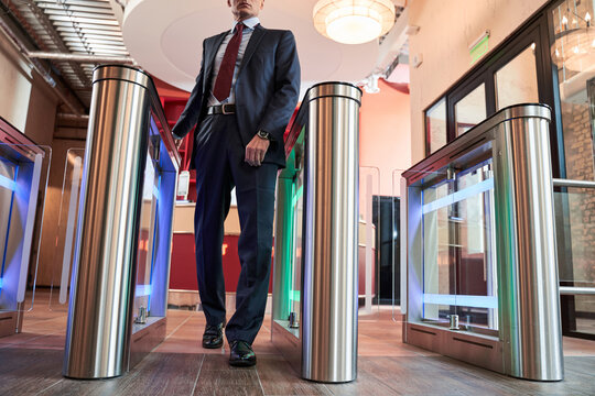 Man entering office via turnstile