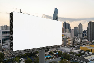 Blank white road billboard with Bangkok cityscape background at sunset. Street advertising poster, mock up, 3D rendering. Side view. The concept of marketing communication to promote or sell idea.