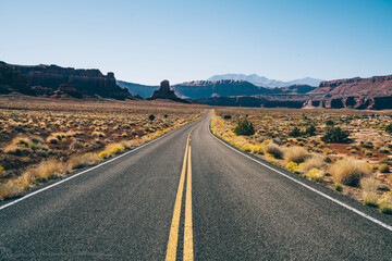 Fototapeta na wymiar Empty asphalt road through dry valley in USA