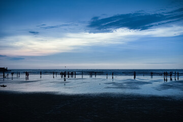 Fototapeta na wymiar Evening cool look of Murudeshwara beach with dark blue sky and clouds rolling over the sea.