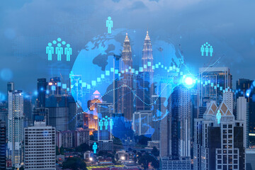 Glowing Social media icons on night panoramic city view of Kuala Lumpur, Malaysia, Asia. The concept of networking and connections between people and businesses in KL. Double exposure.